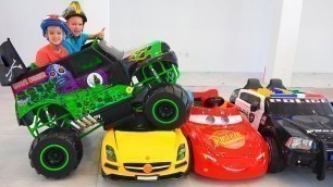 'Vlad and Nikita ride on toy monster truck and goes through the cars for kids'